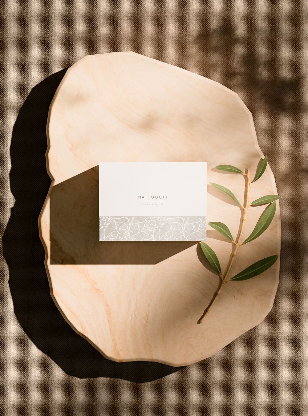 Nattogutt dietary drink box on a wooden board with an olive branch
